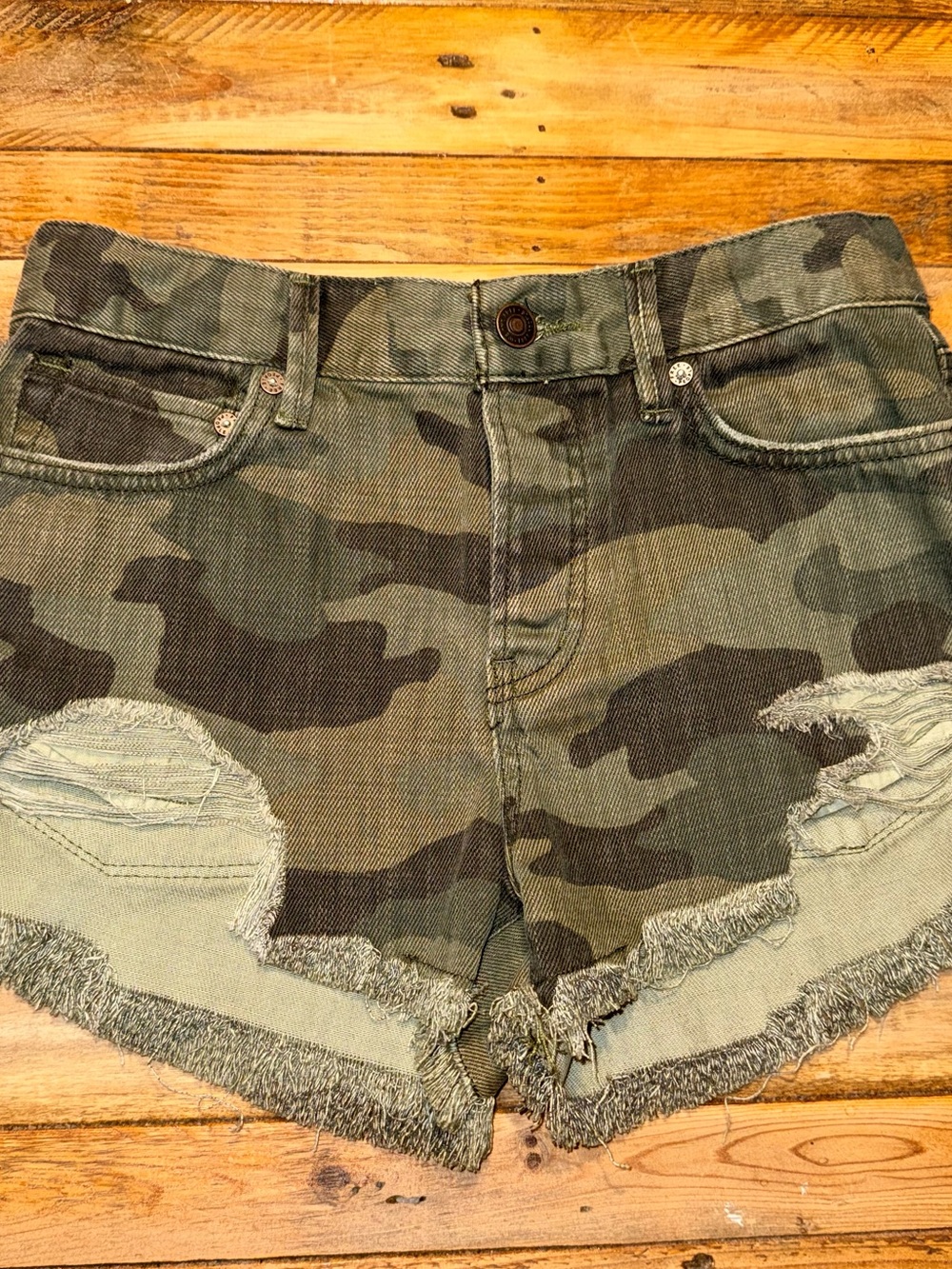 We The Free by Free People Camo Distressed Denim Shorts in Olive Green- 24